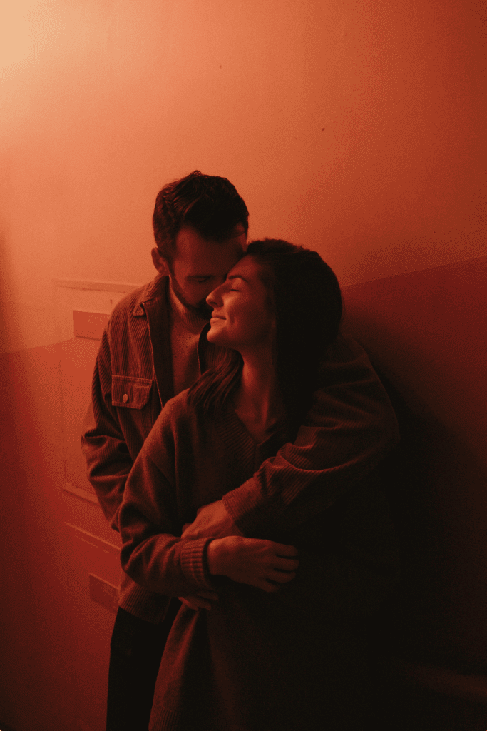 Couple embracing in red light