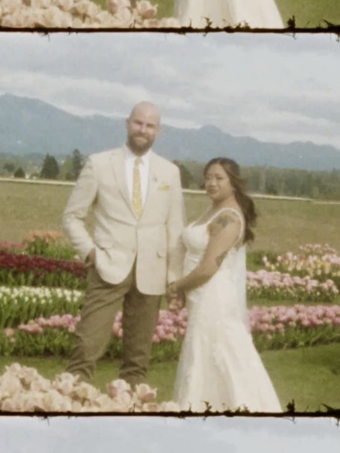 Super8 photo of a couple in wedding attire standing in the Skagit Valley Tulip Fields