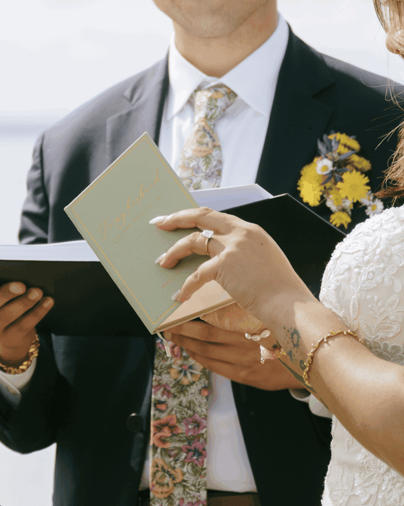 A bride opening her vow book during her elopement ceremony